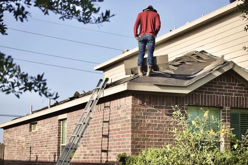 Professional roofer working on a residential roof in Indiana